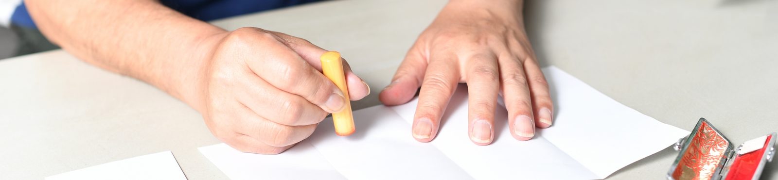 書類に印鑑を押す、高齢の方の手元